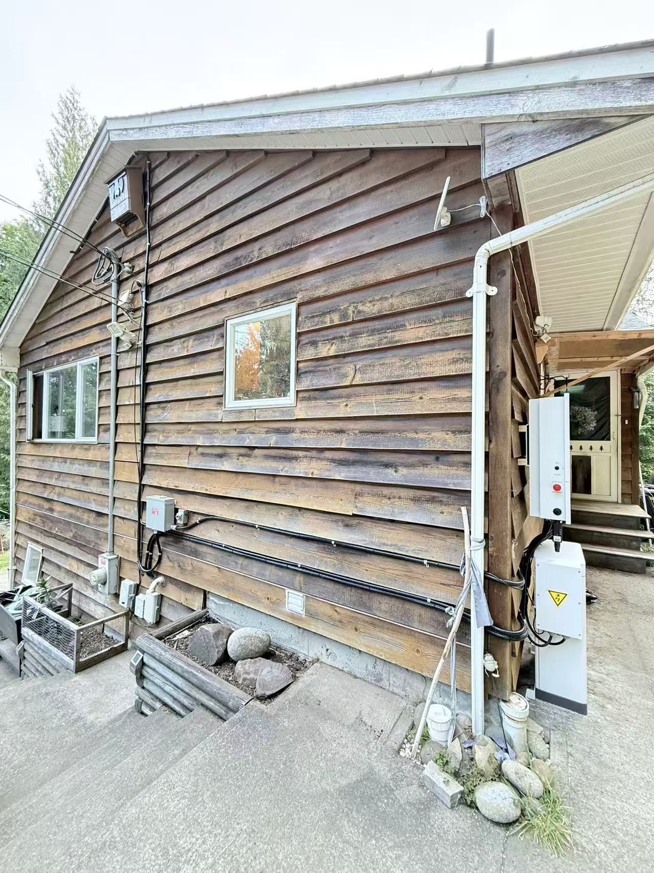 Electrical equipment and conduit installed on the exterior of a log house