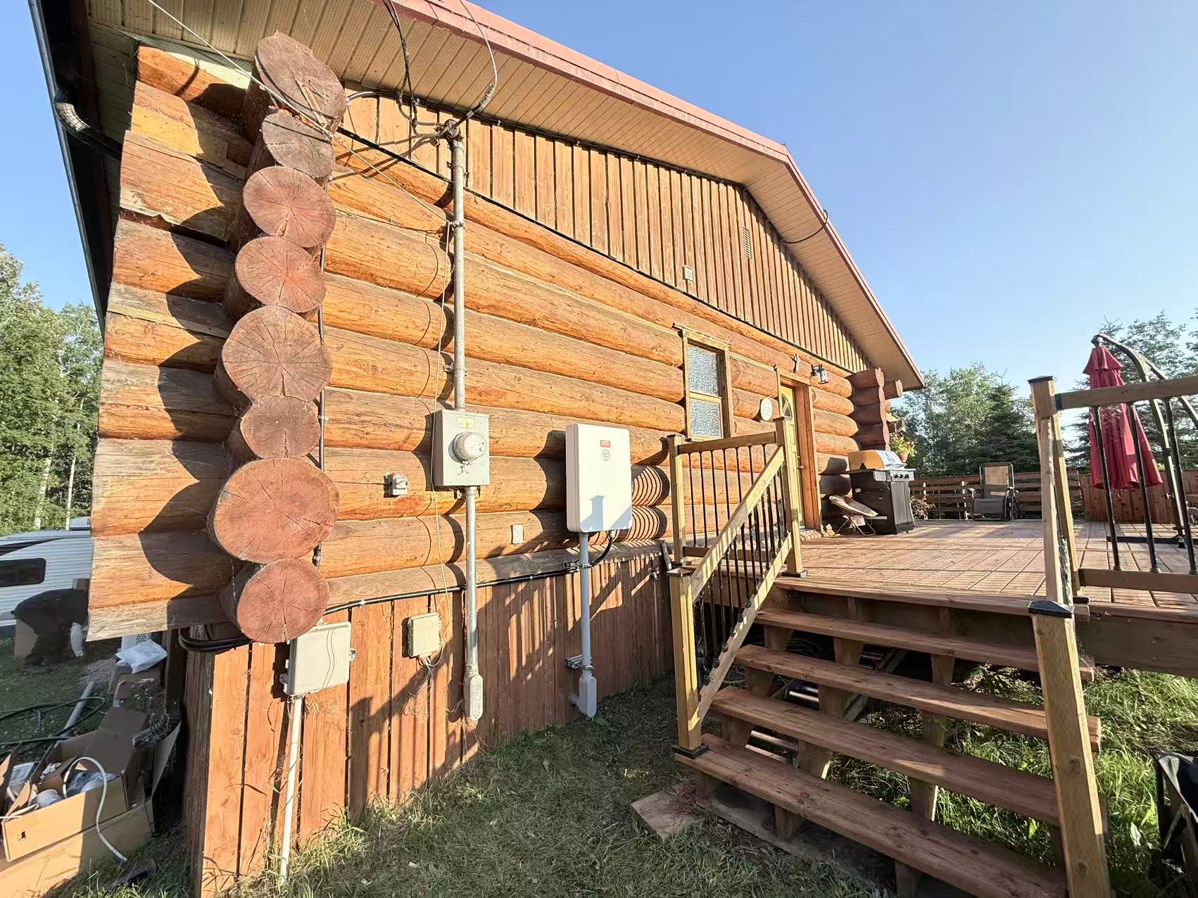 Electrical meter and disconnect equipment mounted on a log cabin exterior