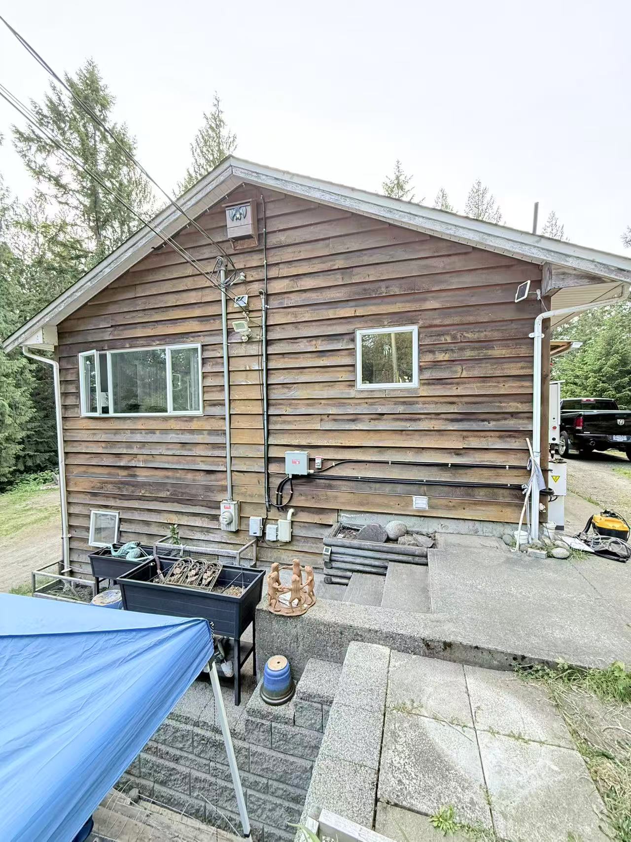 Log house exterior with electrical equipment and conduit