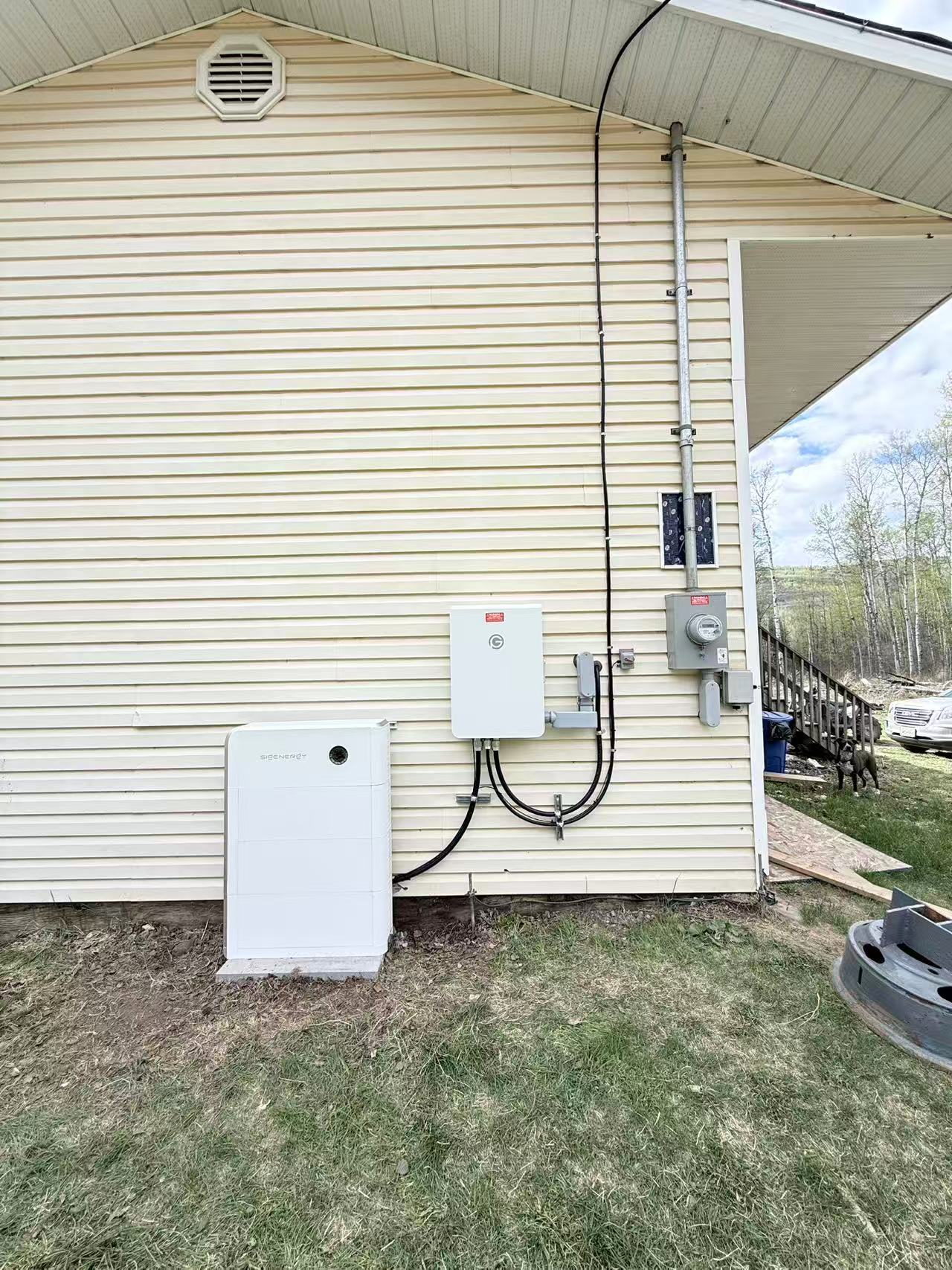 Close view of white Sigenergy equipment installed on an exterior wall